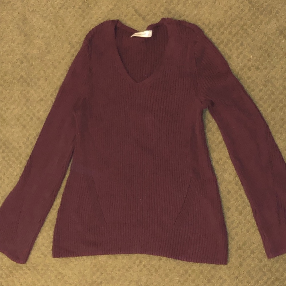 Scoop neck bell sleeve sweater.
